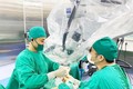 Ê-kíp bác sỹ bệnh viện Đa khoa tỉnh Thanh Hóa đã xuyên đêm tiến hành phẫu thuật nối cẳng chân đứt rời cho bệnh nhân bằng kính vi phẫu. Ảnh: TTXVN phát