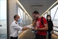 Nhân viên y tế kiểm tra phiếu khai báo y tế của hành khách trước khi làm thủ tục nhập cảnh tại cửa khẩu Sân bay quốc tế Nội Bài (Hà Nội). Ảnh tư liệu: Dương Giang/TTXVN
