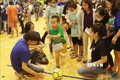 Các chuyên viên can thiệp hướng dẫn trẻ tự kỷ chơi bóng đá. Ảnh: Đinh Hằng - TTXVN