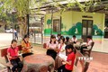 Học sinh đọc sách tại khu vực đọc ngoài trời của Thư viện Cầu vồng, Trưởng Tiểu học Tứ Quận, huyện Yên Sơn. Ảnh: Quang Cường – TTXVN 