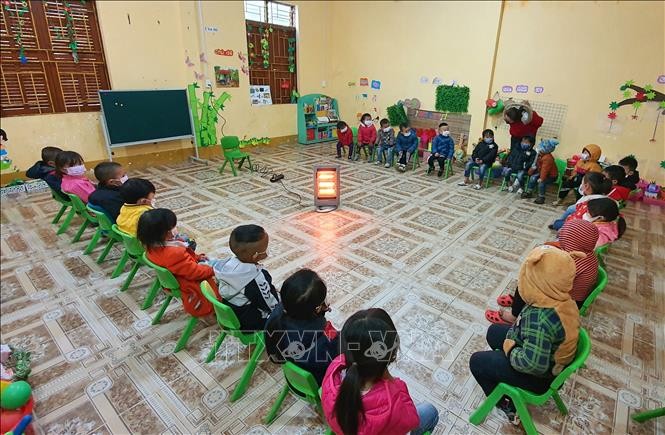 Học sinh Trường Mầm non xã Pả Vi, xã Pả Vi, huyện Mèo Vạc (Hà Giang) được sưởi ấm bằng quạt sưởi. Ảnh: Nguyễn Chiến - TTXVN