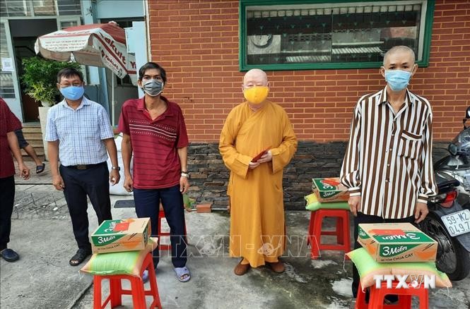 Các chư tăng Quận 11 (thành phố Hồ Chí Minh) tặng nhu yếu phẩm cho người dân nghèo gặp khó khăn do dịch COVID-19. Ảnh: TTXVN phát
