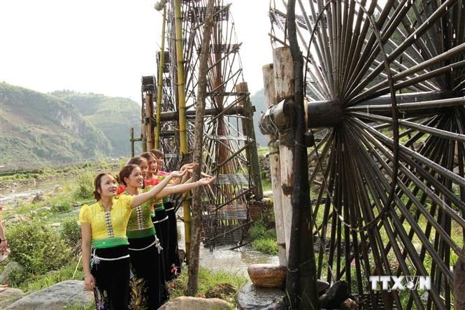 Các cô gái dân tộc Thái bên những guồng nước ở xã Ngọc Chiến, huyện Mường La, tỉnh Sơn La. Ảnh: Nguyễn Cường - TTXVN