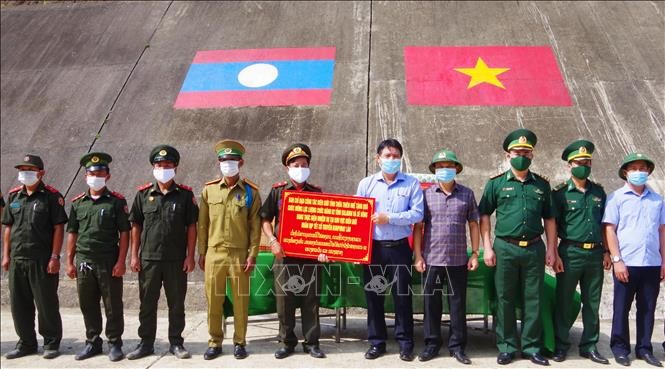 Chúc Tết Bunpimay và tặng quà cho người dân, lực lượng vũ trang Lào. Ảnh: Tường Vi – TTXVN