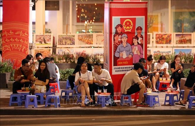 Nhiều người dân vẫn tụ tập đông người không giữ khoảng cách tại phố Lê Thái Tổ, Hoàn Kiếm (ảnh chụp tối 2/5/2021). Ảnh: Phạm Kiên - TTXVN