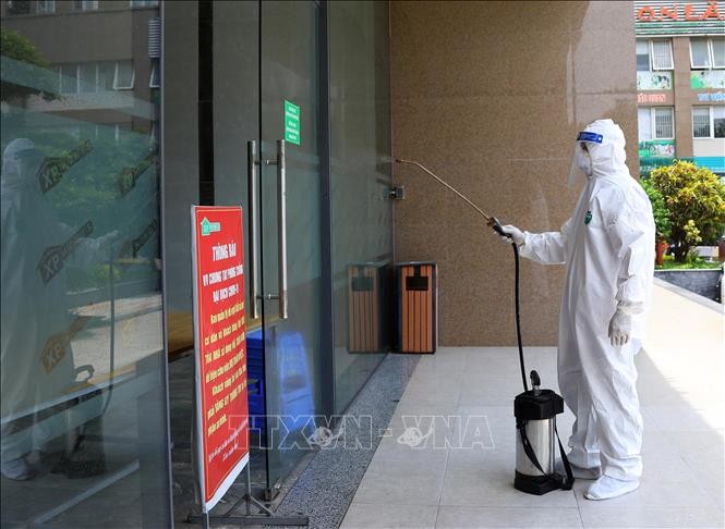 Lực lượng y tế tiến hành phun khử khuẩn tại tòa nhà HHA ở xã Tân Lập (Đan Phượng) vì có các ca mắc COVID-19. Ảnh: Nguyễn Điệp - TTXVN