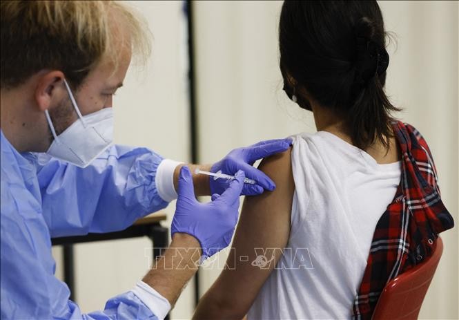 Nhân viên y tế tiêm vaccine ngừa COVID-19 cho người dân tại Berlin, Đức. Ảnh: AFP/TTXVN