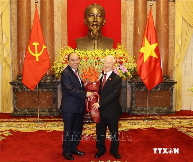 Chủ tịch nước Nguyễn Xuân Phúc tặng hoa Tổng Bí thư Nguyễn Phú Trọng, nguyên Chủ tịch nước. Ảnh: Trí Dũng – TTXVN