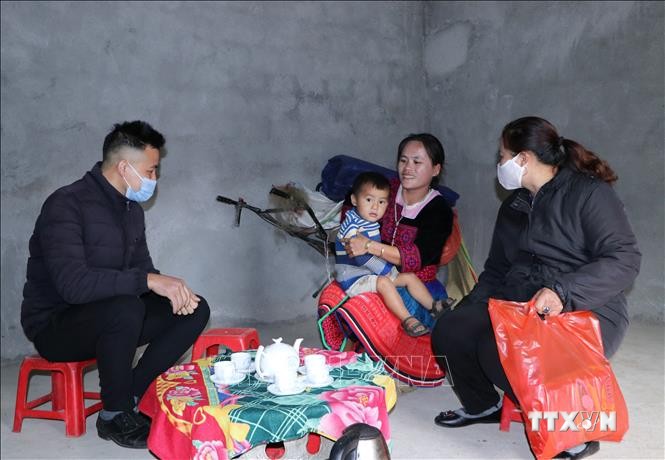 Chủ tịch Hội Liên hiệp phụ nữ xã Sơn Bình, huyện Tam Đường tới thăm gia đình nghèo Má Thị Mỷ, ở bản Chu Va 12 khi được ăn Tết trong ngôi nhà mới. Ảnh: Đinh Thùy-TTXVN