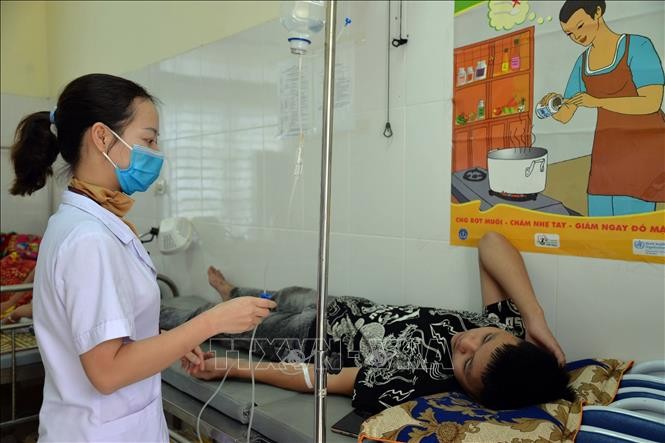 Nhân viên y tế tại Trạm Y tế xã Chiềng Cọ điều trị cho các học sinh nghi ngộ độc thực phẩm. Ảnh: TTXVN phát