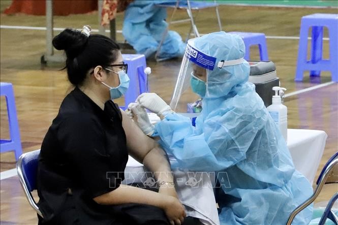  Nhân viên y tế tiêm vaccine cho người dân tại Nhà thi đấu Lãnh Binh Thăng (Quận 11, Thành phố Hồ Chí Minh). Ảnh: Hồng Giang - TTXVN